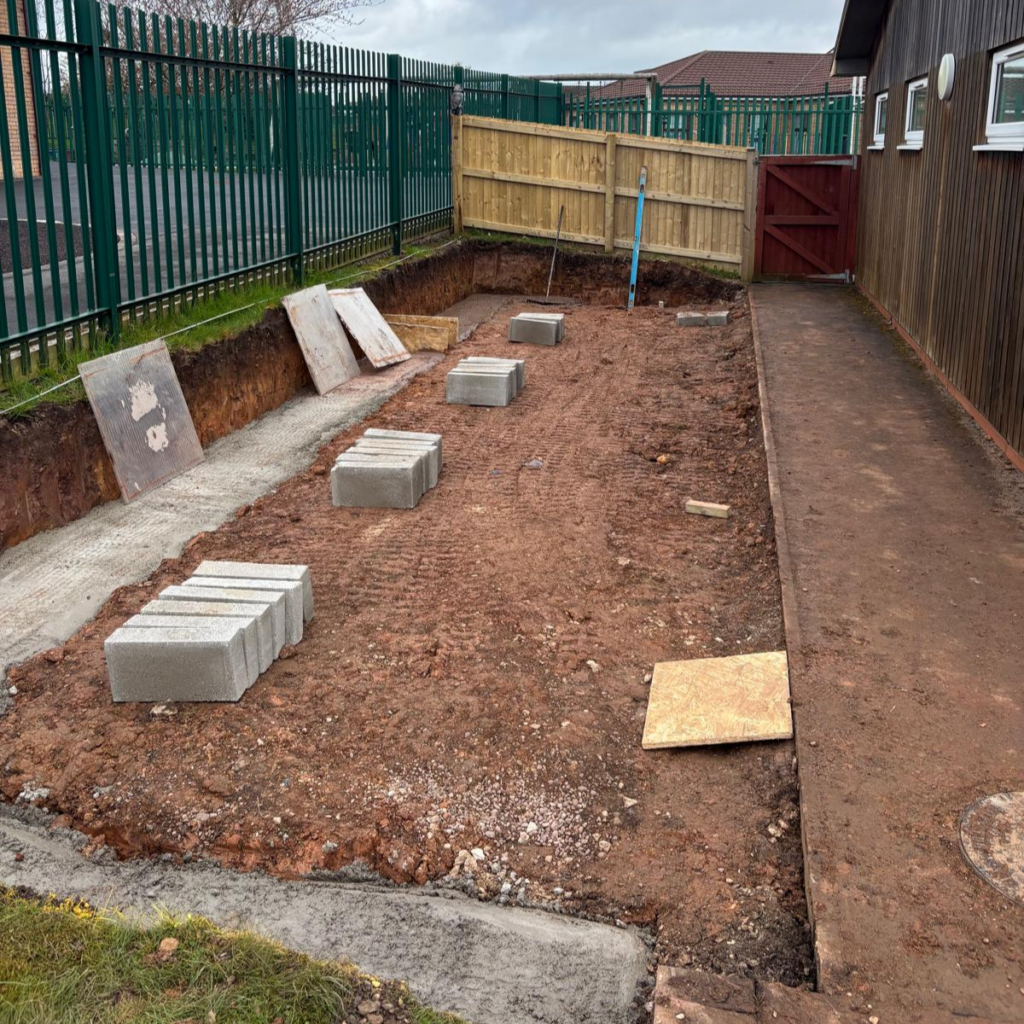 An area that has been dug out with concrete footings laid.