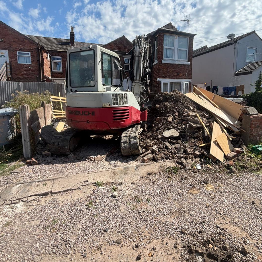 A mini digger loading soil